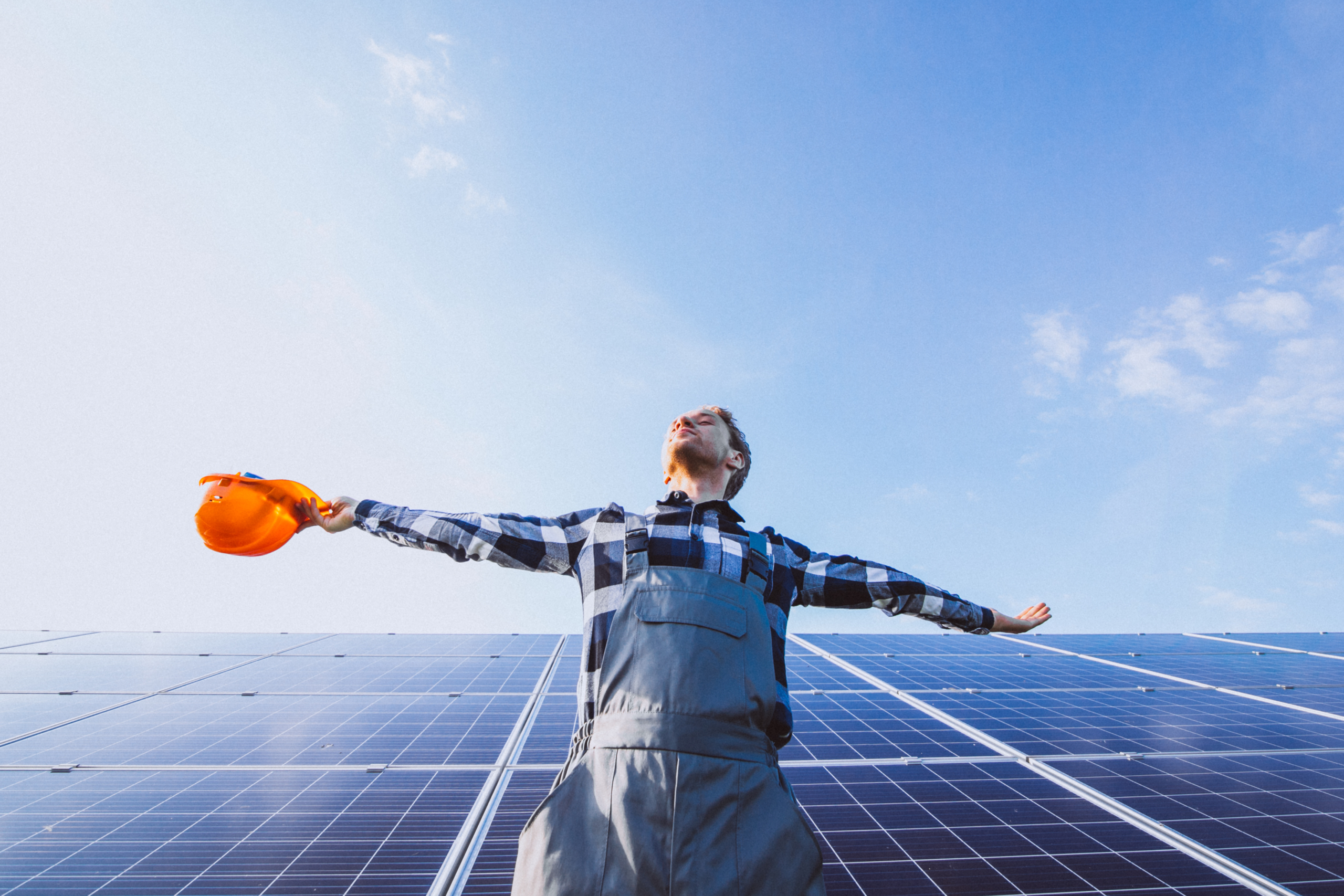 man worker firld by solar panels scaled